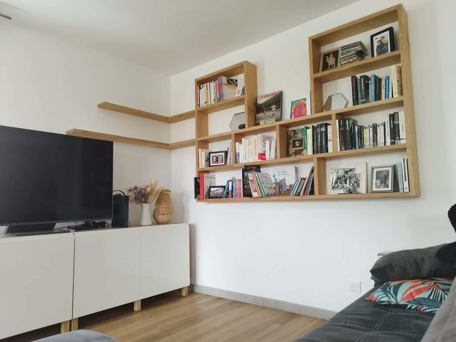 Étagères en bois installées autour d’un meuble de salon